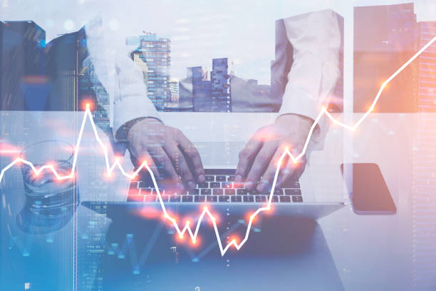 istock Businessman typing on laptop, forex graph, city 1032851514