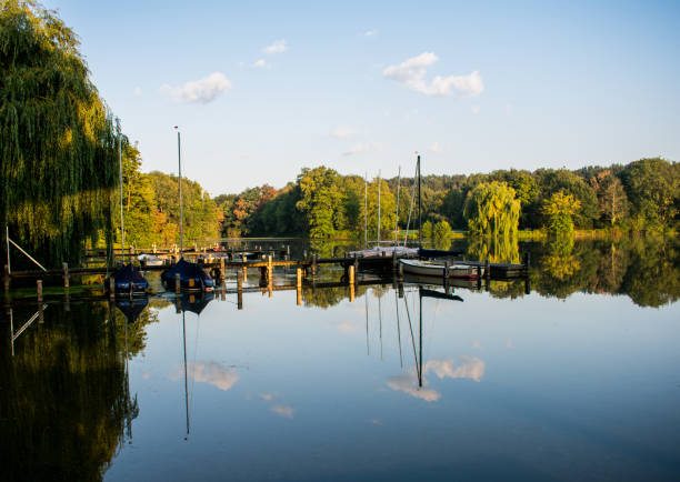 istock romantic jetty with reflections in the water. 1032865718