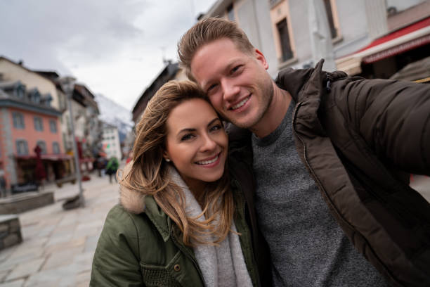 istock Loving couple taking a selfie while sightseeing in the winter 1032869704