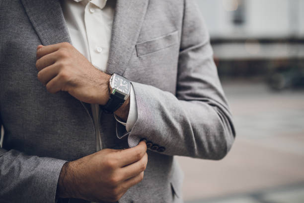istock Business man fixing buttons on suit jacket 1032873924
