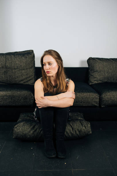 istock Alone and anxious young woman at home 1032876810