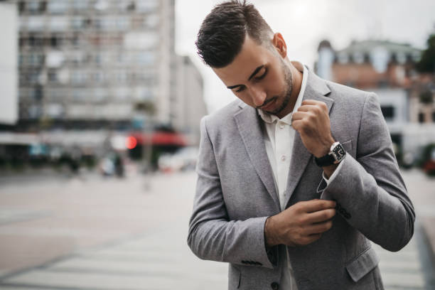 istock Business man fixing buttons on suit jacket 1032877196