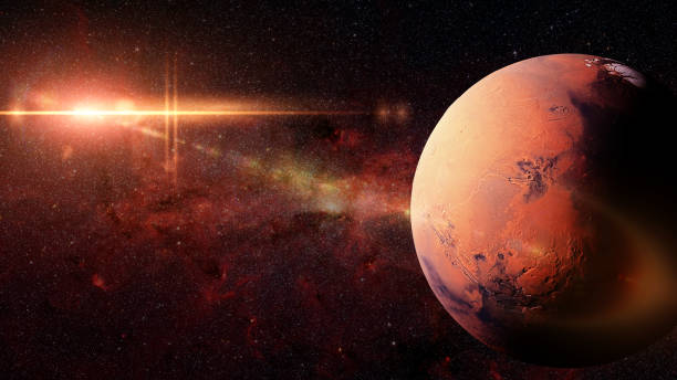 istock planet Mars in front of the galaxy and the sun 1032881928