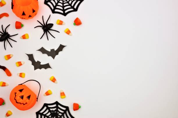 Halloween side border of candy and decor, flat lay over white Halloween side border of scattered candy and decor. Flat lay over a white background. Copy space. spider photos stock pictures, royalty-free photos & images