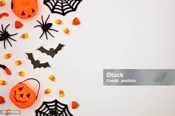 Halloween Side Border Of Candy And Decor Flat Lay Over White Stock Photo - Download Image Now