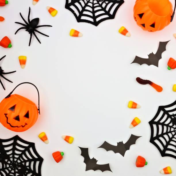 istock Halloween frame of candy and decor, flat lay over white 1032890630
