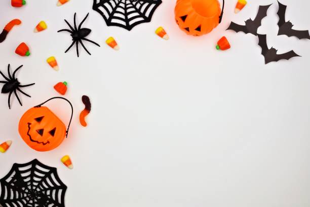 istock Halloween corner border of candy and decor, flat lay over white 1032890668