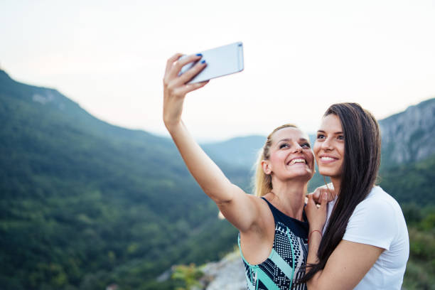 istock Friends take selfie on mountain range 1032890780