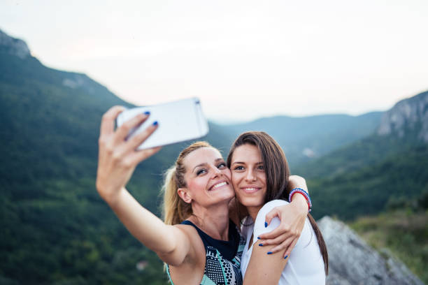 istock Friends take selfie on mountain range 1032895710