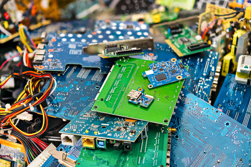 Connectors, PCB, notebook cards. Colorful blurry background from PC components. Mainboards, integrated circuit boards, UTP, USB. Idea of electronics industry, eco, sorting and disposal of electronic waste