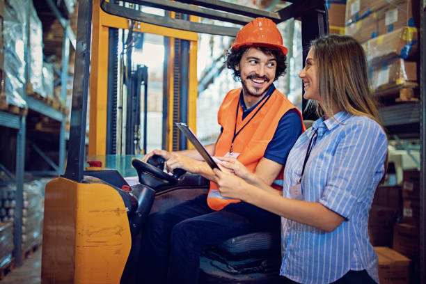 istock Manager is giving instructions to forklift operator in the warehouse 1032916566