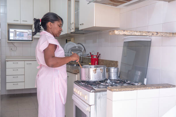 istock Brazilian maid cooking 1032925148