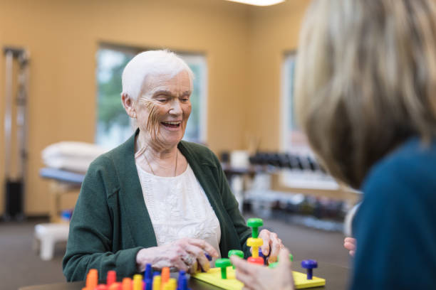istock Occupational therapist works with an elderly woman 1032930990