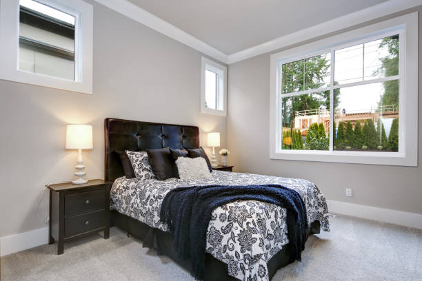 istock Guest modern bedroom interior with grey walls and windows 1032940716