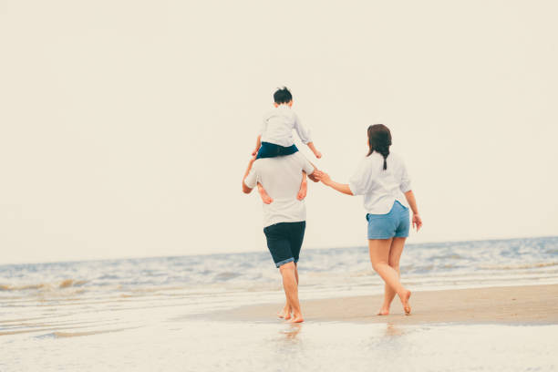 istock Happy family goes vacation on the beach in summer. 1032940904