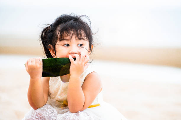 istock Adorable kid eating watermelon on the beach. 1032940914