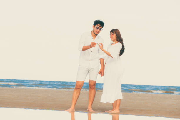 istock Couple going honeymoon on tropical beach in summer 1032940952