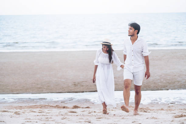 istock Happy young couple walk on the beach on honeymoon. 1032941078