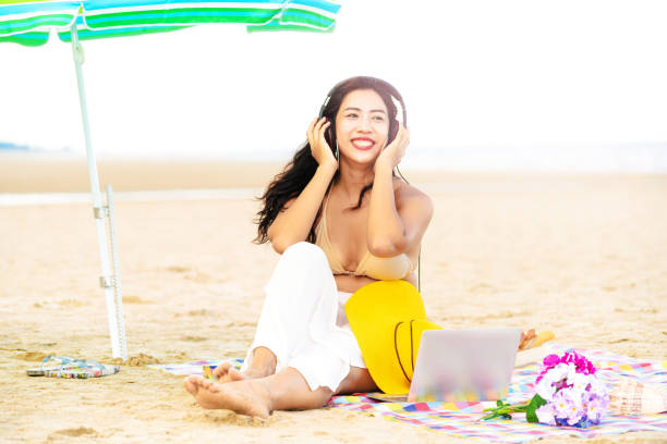 istock Plus size young woman sitting on the beach. 1032941092