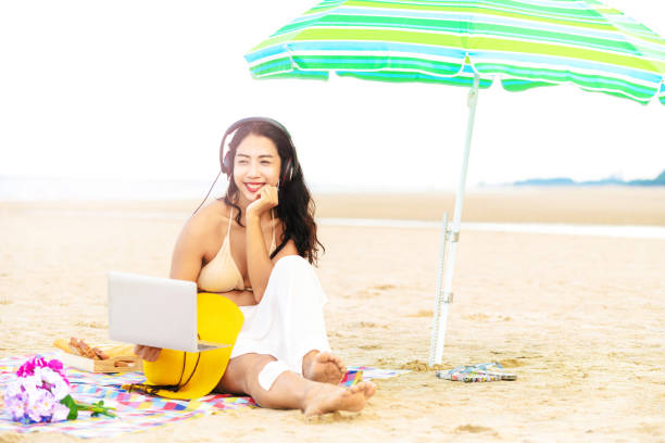 istock Plus size young woman sitting on the beach. 1032941094