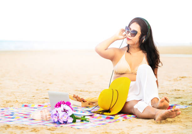 istock Plus size young woman sitting on the beach. 1032941096