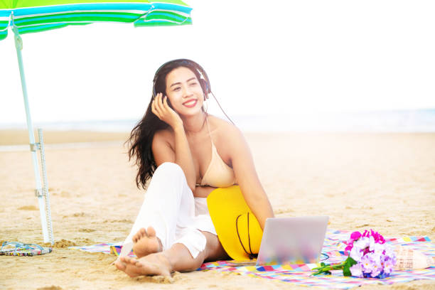 istock Plus size young woman sitting on the beach. 1032941132
