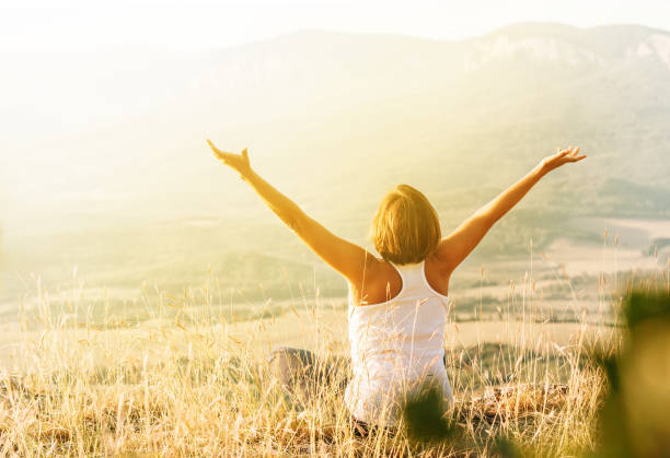 istock Woman meets sunrise in mountain 1032945314