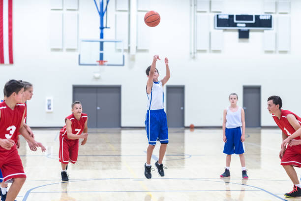 istock Co-ed teen basketball team playing a game 1032950352