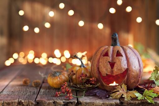 Halloween pumpkin arrangement with lights against an old rustic wood background
