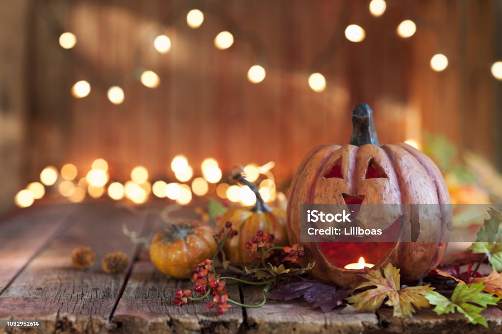 Halloween Pumpkin against an old wood background Halloween pumpkin arrangement with lights against an old rustic wood background Halloween Stock Photo