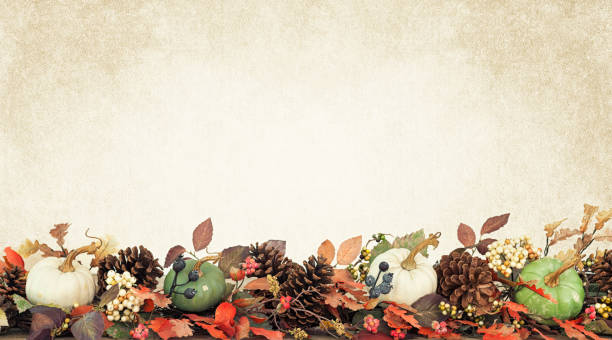 Thanksgiving autumn harvest pumpkin garland on a texture and toned background