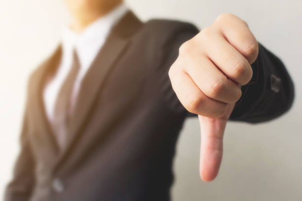 istock Businessman hand showing thumb down sign gesture. Dislike or bad concept 1032967644