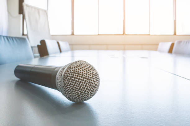 Closeup view microphone on table in meeting room with blurred background