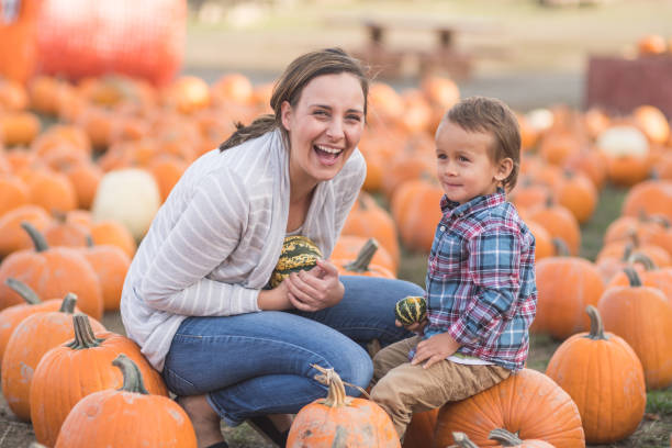 istock Mom and her little boy at the pumpkin patch 1032983298