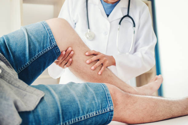 istock Doctor consulting with patient Knee problems Physical therapy concept 1033011042