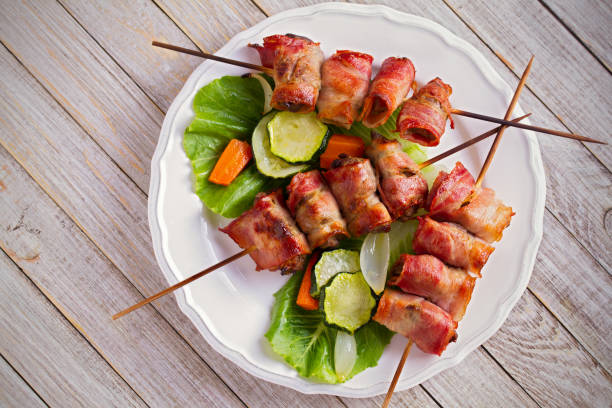 istock Chicken liver wrapped with bacon on skewers. Grilled liver kebabs 1033018038