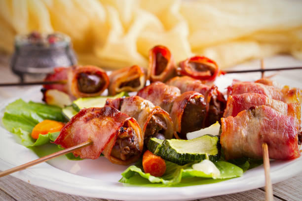 istock Chicken liver wrapped with bacon on skewers. Grilled liver kebabs 1033018256