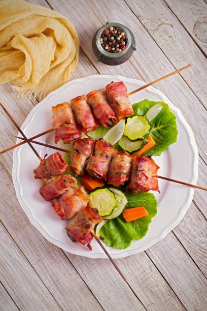 istock Chicken liver wrapped with bacon on skewers. Grilled liver kebabs 1033018314