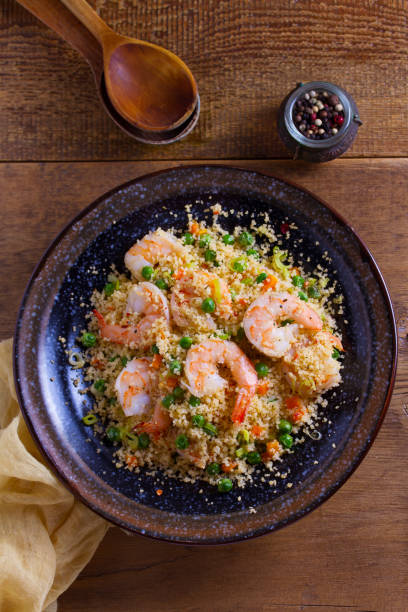 istock Shrimps with couscous, green peas, leeks and carrot 1033022542