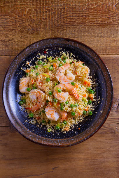 istock Shrimps with couscous, green peas, leeks and carrot 1033022678