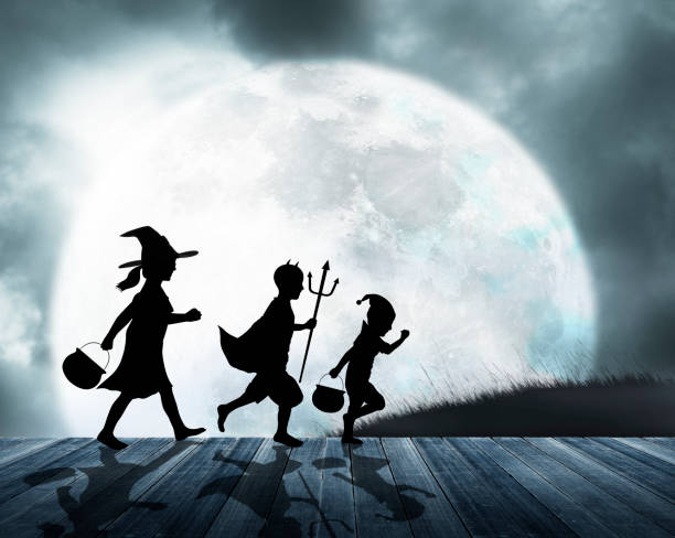 istock Three Children Dressed Up For Halloween Silhouetted Against Moon 1033027994