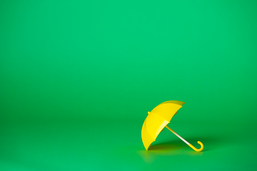 Green background and yellow umbrella
