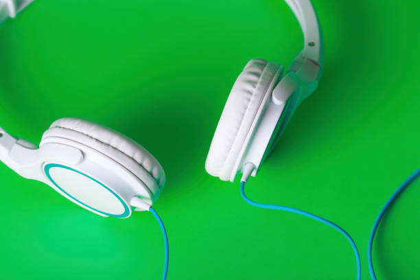 istock Green background and headphones 1033028234