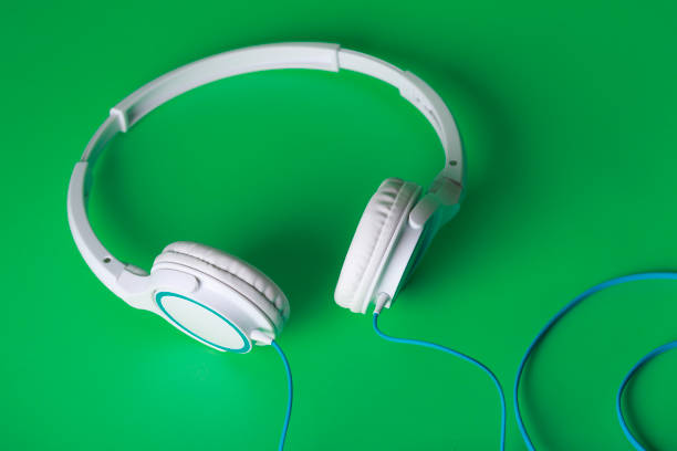 istock Green background and headphones 1033028242
