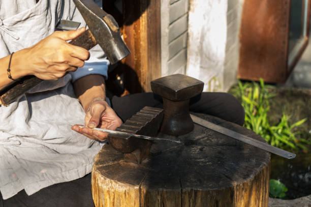 istock Craftsmen are making jewelry,Hammering silver ornaments with hammers 1033033536