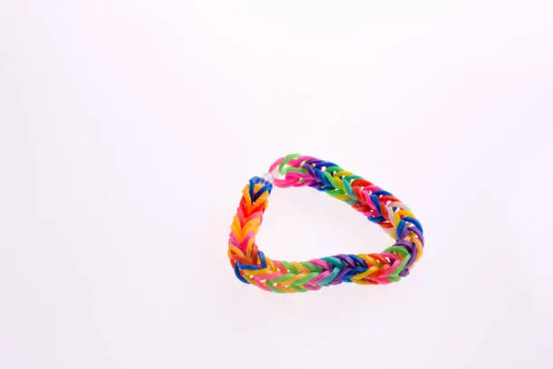 Color rubber hairclips connected on a white background