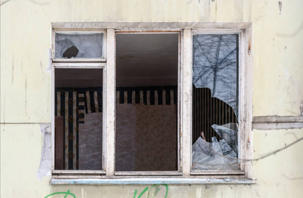 istock Broken window. Abandoned dwelling house in Russia 1033034504