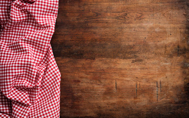 istock Red white checkered picnic tablecloth on wooden background, copy space 1033034628