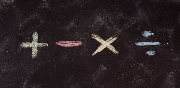 istock Mathematical symbols written with colorful chalks, isolated, on blackboard background. 1033037246