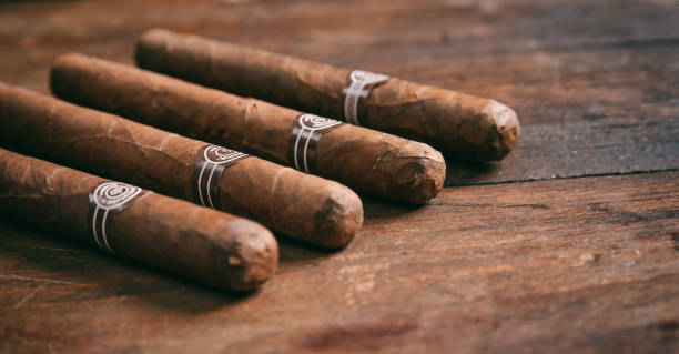Cigars on wooden background, copy space Cuban cigars on wooden background, copy space cigar photos stock pictures, royalty-free photos & images